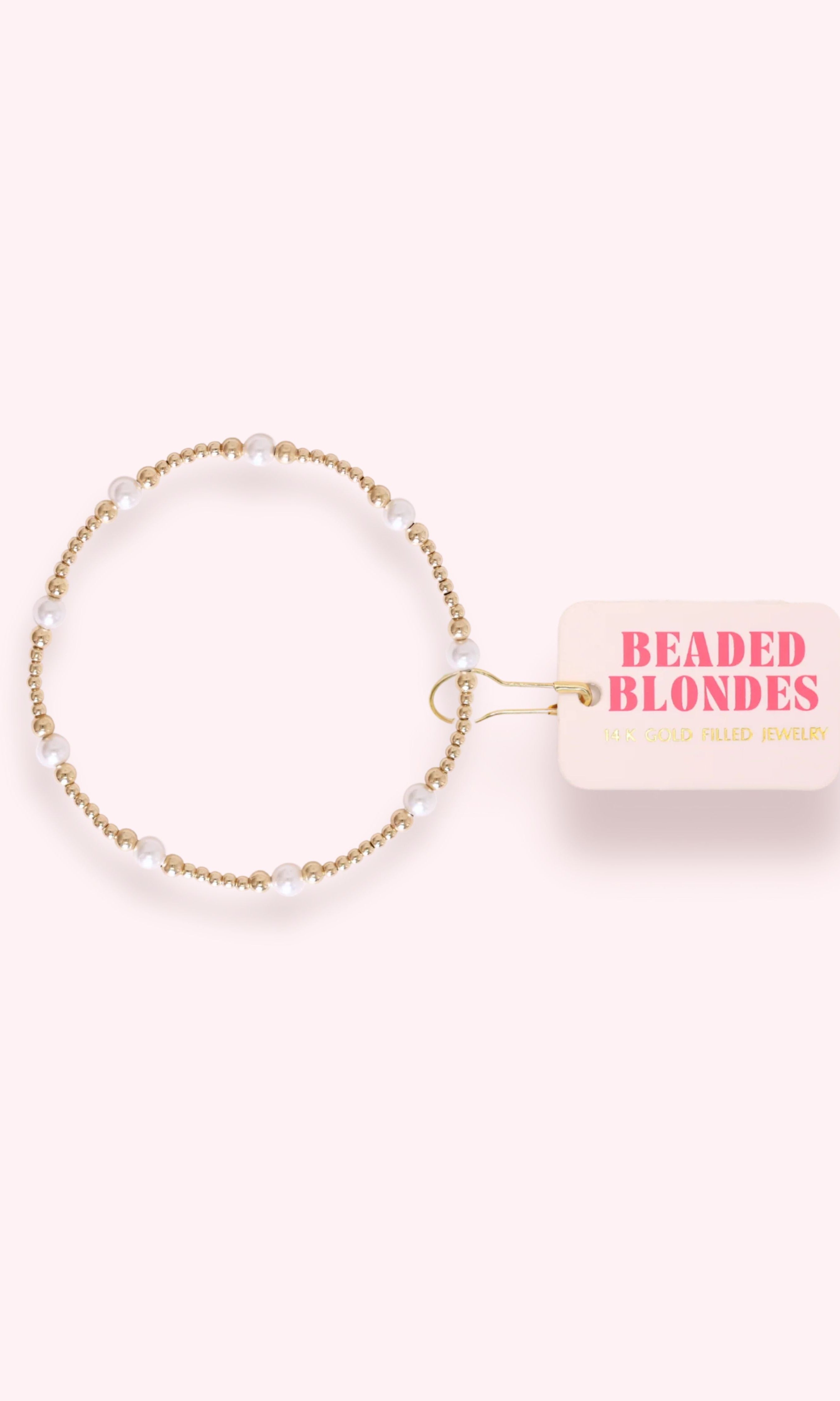 Beaded bracelet on a 'Beaded Blondes' branded card against a white background